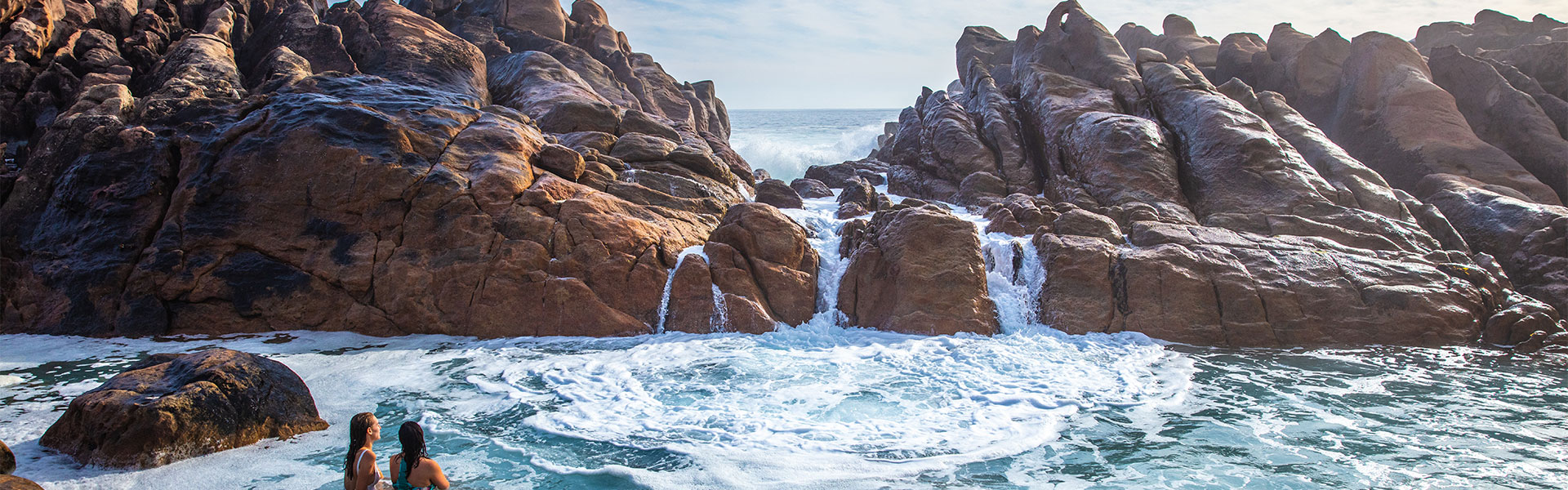 Two women having a dip in Injidup Natural Spa, Yallingup, Western Australia